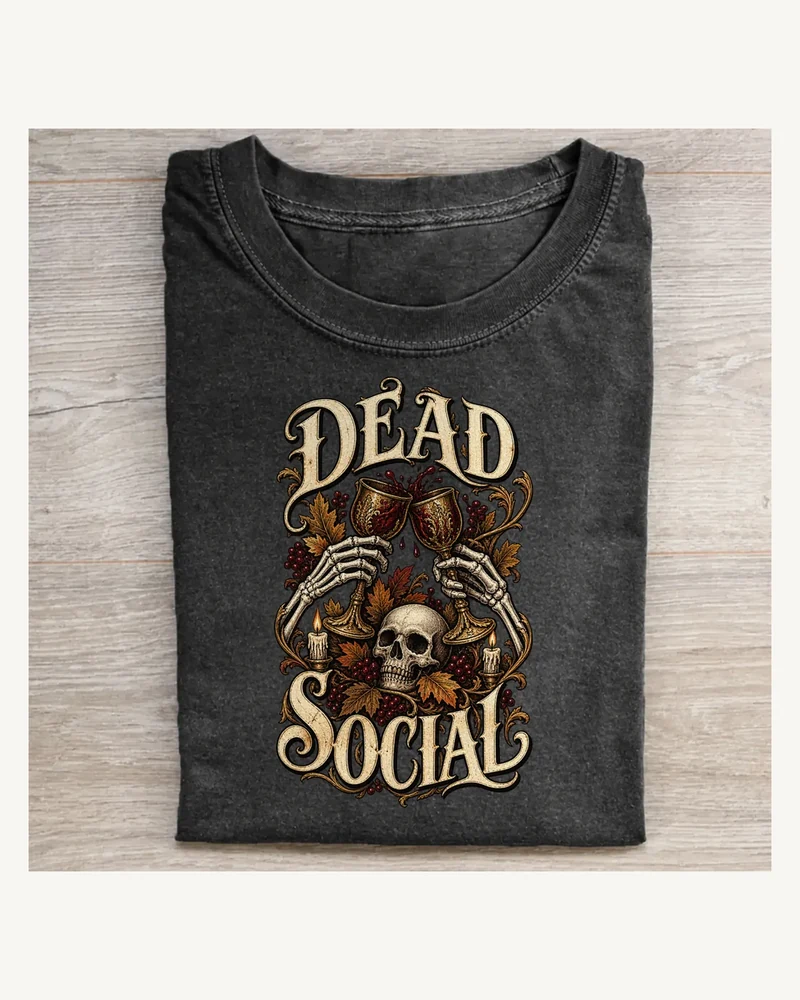 Folded washed black T-shirt featuring DEAD SOCIAL gothic lettering and Halloween artwork